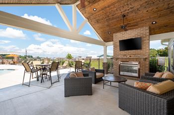 Outdoor pavilion with fireplace, flat screen tv, and food area